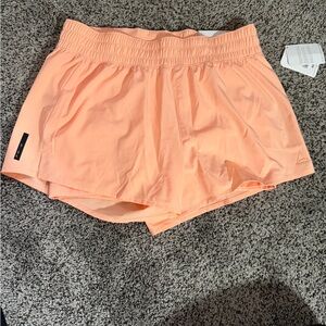 Reebok Women's Peach Shorts with bike shorts under. Size large